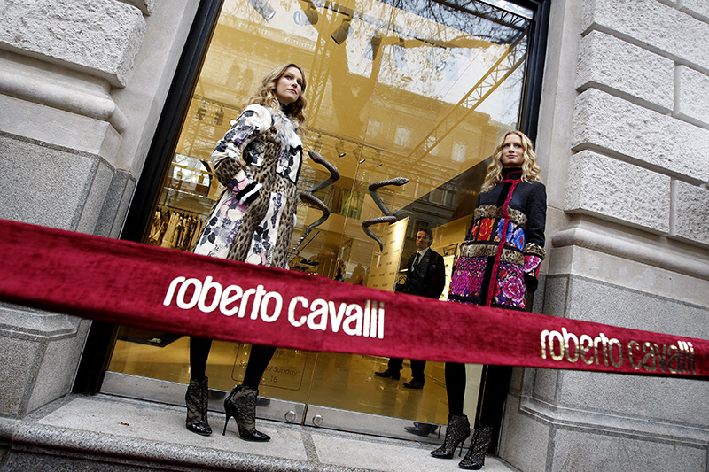 Models stand at the front of the door during the opening ceremony of Italian designer Roberto Cavalli's fashion house in Budapest