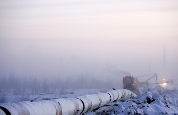 A vehicle passed the Gazprom pipeline under construction in Novy Urengoy