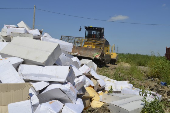 Handout photo of an employee operating a bulldozer while destroying illegally imported food falling under restrictions in Belgorod region