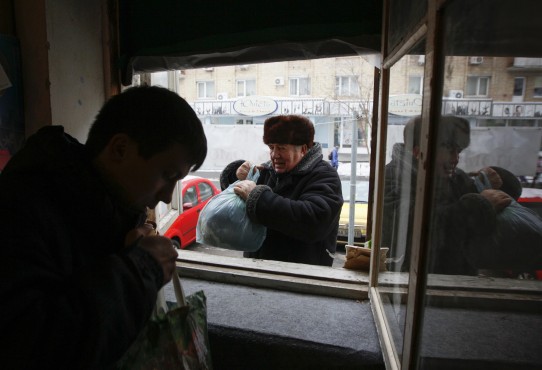 A man donates clothing to a volunteer centre in Kiev